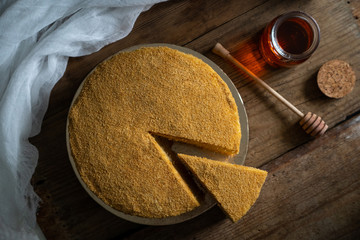 honey cake. jar of honey. hand with a spoon for honey. honey drips from a spoon