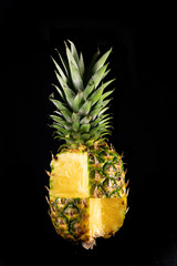 Pineapple cut in checkerboard, on black