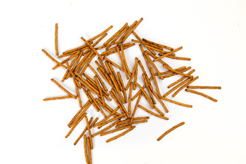 overhead view of a pile of pretzel sticks on white