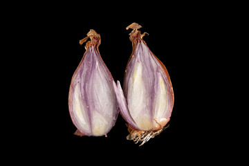 Shallot cut in half, on a black background