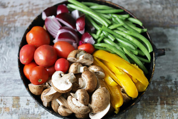 Colored vegetables in a pan before baking. Vegan recipe. Healthy bright food.