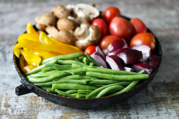 Colored vegetables in a pan before baking. Vegan recipe. Healthy bright food.