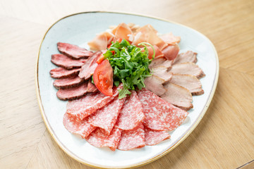 Meat plate, delicacy and Anantipasto. Salami, roast beef, Parma ham, smoked duck breast. Restaurant menu.