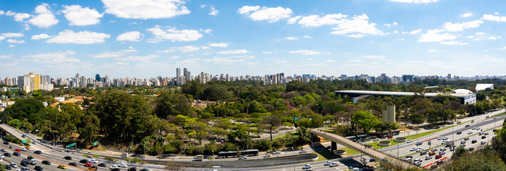 Fototapeta na wymiar View of Ibirapuera Park and buildings of the Sao Paulo city in sunny afternoon. Brazil.