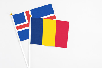 Chad and Iceland stick flags on white background. High quality fabric, miniature national flag. Peaceful global concept.White floor for copy space.