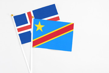 Congo and Iceland stick flags on white background. High quality fabric, miniature national flag. Peaceful global concept.White floor for copy space.