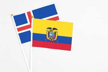 Ecuador and Iceland stick flags on white background. High quality fabric, miniature national flag. Peaceful global concept.White floor for copy space.