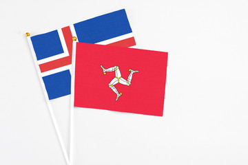 Isle Of Man and Iceland stick flags on white background. High quality fabric, miniature national flag. Peaceful global concept.White floor for copy space.