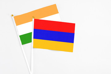 Armenia and India stick flags on white background. High quality fabric, miniature national flag. Peaceful global concept.White floor for copy space.