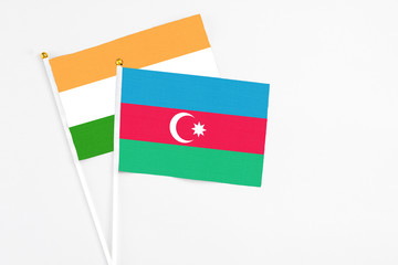 Azerbaijan and India stick flags on white background. High quality fabric, miniature national flag. Peaceful global concept.White floor for copy space.