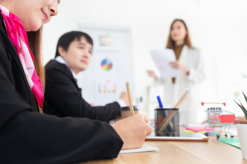 close up hand, asian officer woman use pen to lecture, asian group conference and discussion in meeting room, they feeling happy and hope to plan organization development