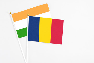 Chad and India stick flags on white background. High quality fabric, miniature national flag. Peaceful global concept.White floor for copy space.