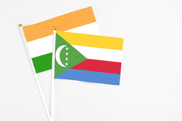 Comoros and India stick flags on white background. High quality fabric, miniature national flag....
