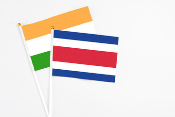 Costa Rica and India stick flags on white background. High quality fabric, miniature national flag. Peaceful global concept.White floor for copy space.