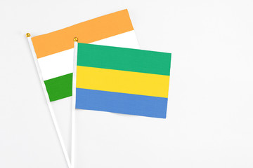Gabon and India stick flags on white background. High quality fabric, miniature national flag....