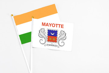 Mayotte and India stick flags on white background. High quality fabric, miniature national flag. Peaceful global concept.White floor for copy space.