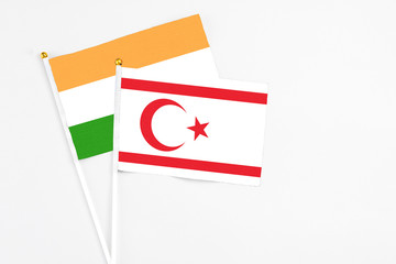 Northern Cyprus and India stick flags on white background. High quality fabric, miniature national flag. Peaceful global concept.White floor for copy space.