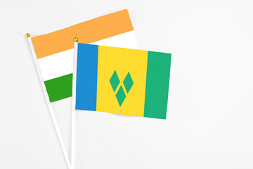 Saint Vincent And The Grenadines and India stick flags on white background. High quality fabric,...