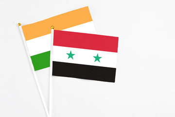 Syria and India stick flags on white background. High quality fabric, miniature national flag....