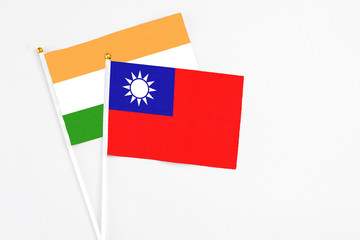 Taiwan and India stick flags on white background. High quality fabric, miniature national flag. Peaceful global concept.White floor for copy space.