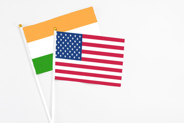 United States and India stick flags on white background. High quality fabric, miniature national flag. Peaceful global concept.White floor for copy space.