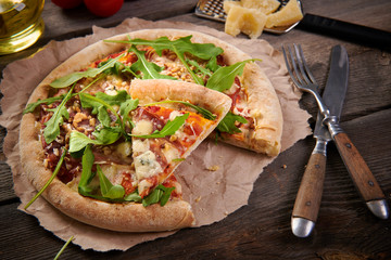 Pizza with prosciutto ham, walnuts, gorgonzola cheese and walnuts