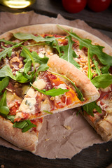 Pizza with prosciutto ham, walnuts, gorgonzola cheese and walnuts