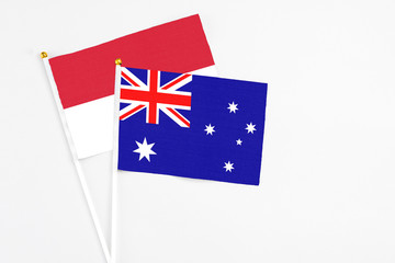 Fototapeta premium Australia and Indonesia stick flags on white background. High quality fabric, miniature national flag. Peaceful global concept.White floor for copy space.