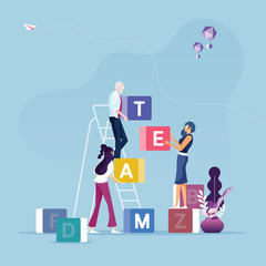 Group of business people carrying cubic box with word TEAM-Concept of teamwork