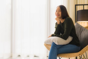 Portrait beautiful young asian women happy smile relax sitting on sofa chair