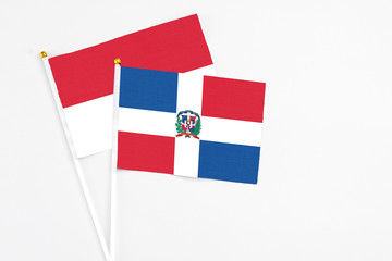 Dominican Republic and Indonesia stick flags on white background. High quality fabric, miniature national flag. Peaceful global concept.White floor for copy space.