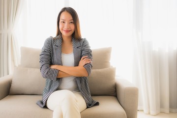 Fototapeta premium Portrait beautiful young asian women happy smile relax sitting on sofa chair