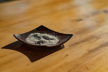 A plate of salt standing on the table