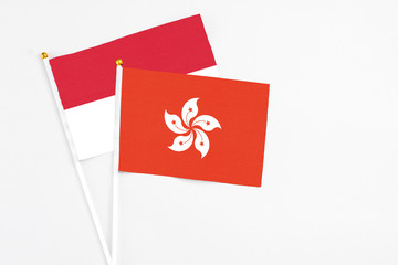 Hong Kong and Indonesia stick flags on white background. High quality fabric, miniature national flag. Peaceful global concept.White floor for copy space.