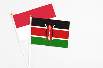 Kenya and Indonesia stick flags on white background. High quality fabric, miniature national flag. Peaceful global concept.White floor for copy space.