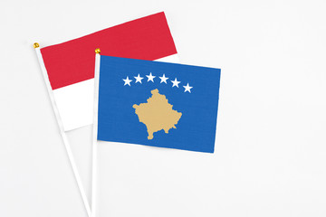 Kosovo and Indonesia stick flags on white background. High quality fabric, miniature national flag. Peaceful global concept.White floor for copy space.