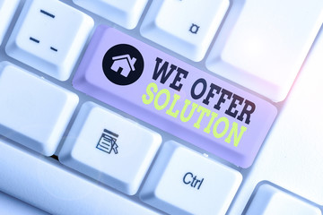 Conceptual hand writing showing We Offer Solution. Concept meaning Provide products or services aim to meet a particular need White pc keyboard with note paper above the white background