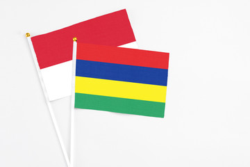 Mauritius and Indonesia stick flags on white background. High quality fabric, miniature national flag. Peaceful global concept.White floor for copy space.