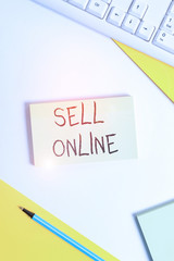 Text sign showing Sell Online. Business photo showcasing directly sell goods or services to a buyer over the Internet Flat lay above table with pc keyboard and copy space paper for text messages