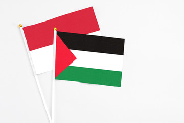 Palestine and Indonesia stick flags on white background. High quality fabric, miniature national...