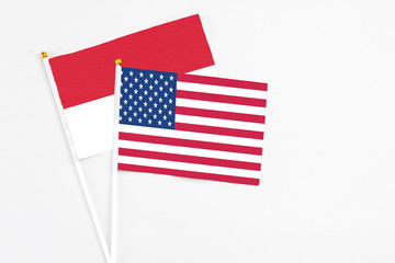 United States and Indonesia stick flags on white background. High quality fabric, miniature national flag. Peaceful global concept.White floor for copy space.