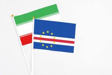 Cape Verde and Iran stick flags on white background. High quality fabric, miniature national flag. Peaceful global concept.White floor for copy space.