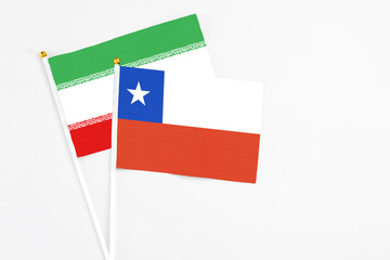 Chile and Iran stick flags on white background. High quality fabric, miniature national flag. Peaceful global concept.White floor for copy space.