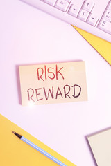 Text sign showing Risk Reward. Business photo showcasing assess the profit potential of a trade relative to its loss Flat lay above table with pc keyboard and copy space paper for text messages