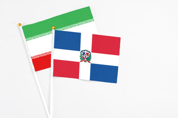 Dominican Republic and Iran stick flags on white background. High quality fabric, miniature...