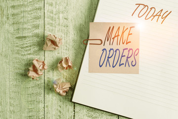 Writing note showing Make Orders. Business concept for A confirmed request by one party to another to buy or sell Notebook stationary placed above classic wooden backdrop