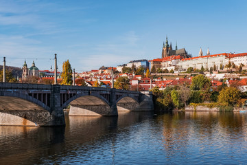 charles bridge in prague with castle on a sunny day