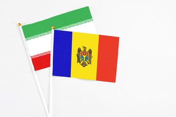 Moldova and Iran stick flags on white background. High quality fabric, miniature national flag. Peaceful global concept.White floor for copy space.