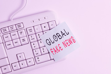 Writing note showing Global Fake News. Business concept for False information Journalism Lies Disinformation Hoax White pc keyboard with empty note paper above white background