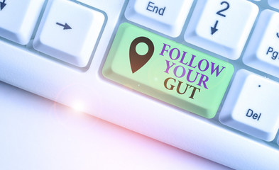 Writing note showing Follow Your Gut. Business concept for Listen to intuition feelings emotions...